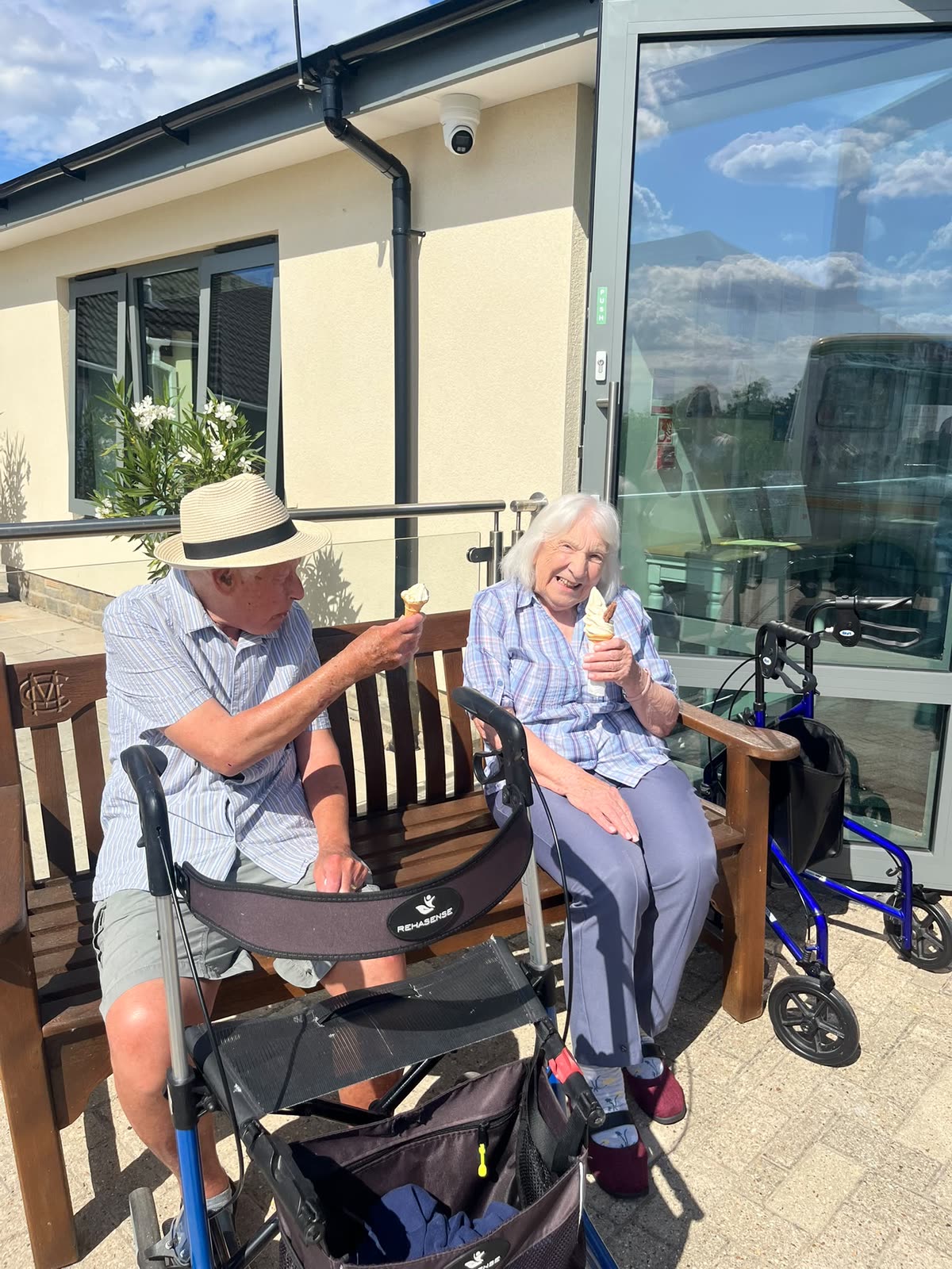 Two residents enjoying ice creams together in the sunshine